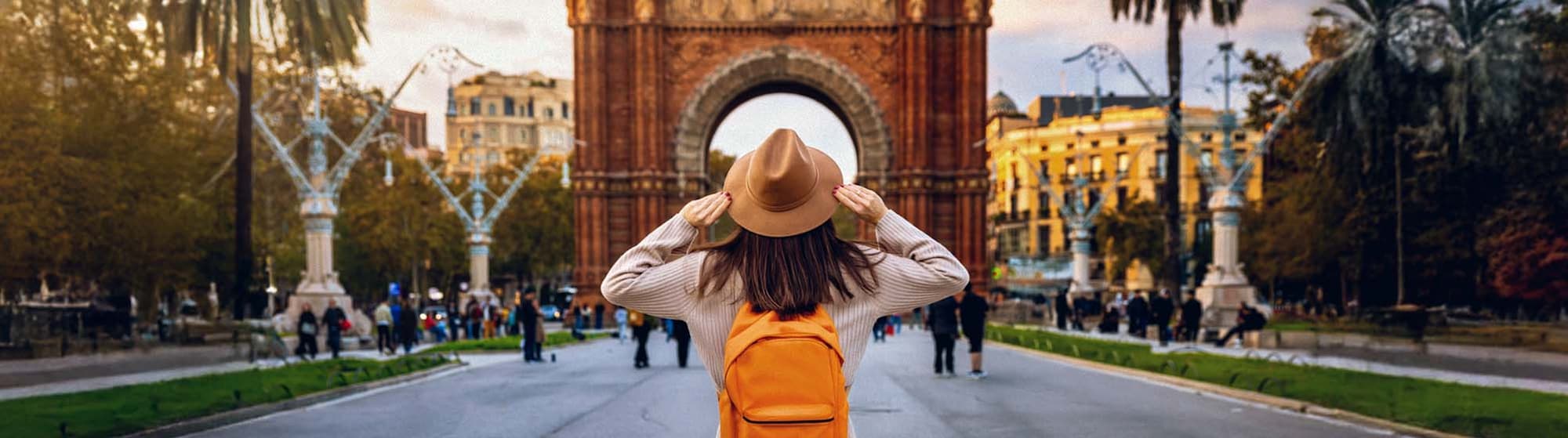 The image shows a woman with an orange backpack and a monument in the background.