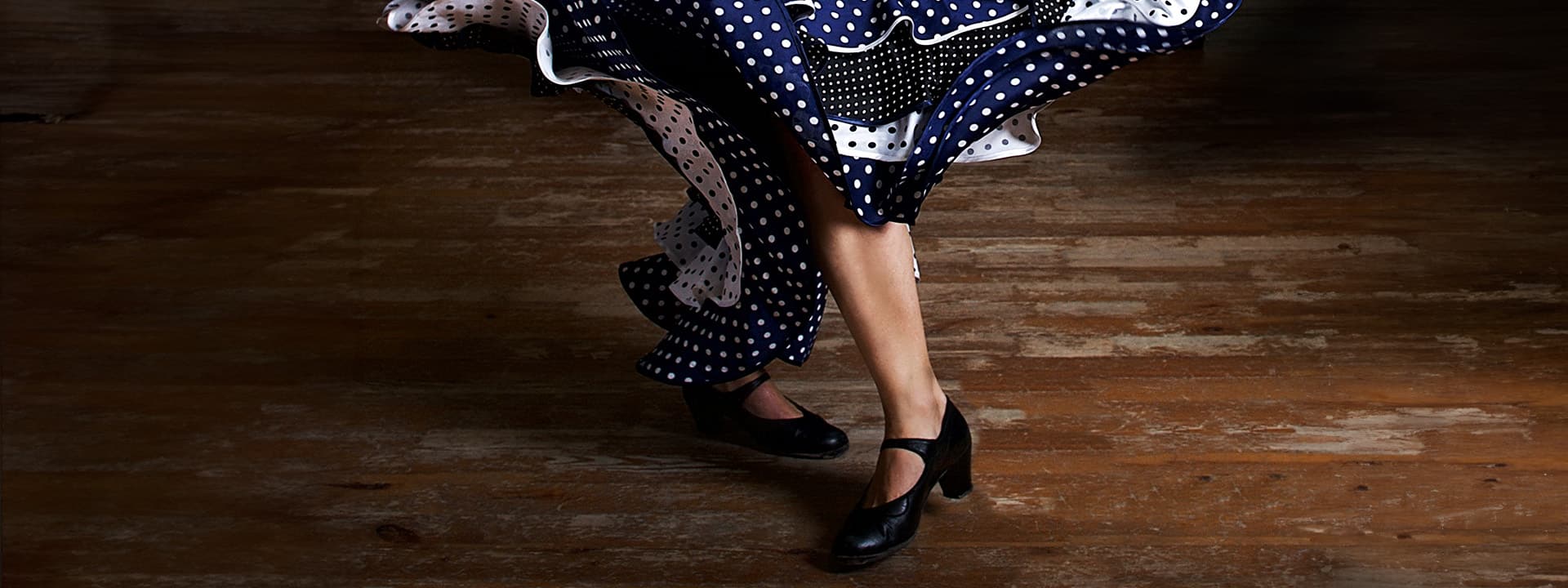 Detail of the legs of a flamenco dancer on stage