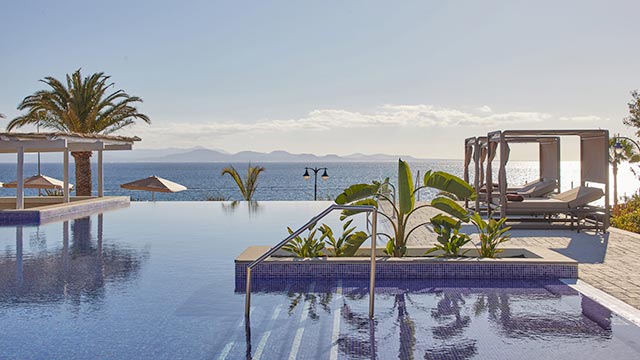 Infinity pool at Dreams Lanzarote Playa Dorada Hotel, a 5-star resort facing the beach.