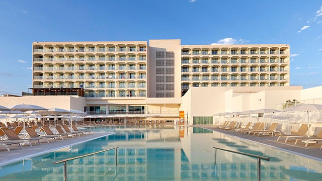 Outdoor pool at Palladium Hotel Menorca, with direct beach access and activities for everyone.