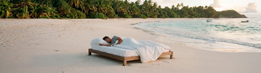 The image shows a man lying in a hammock.