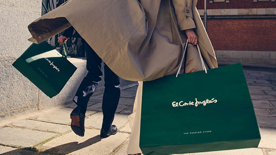 The image depicts a shopping bag emerging from a green box with the caption
